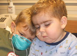 Charles, then 7, comforts William, then 3, in his hospital bed the day before the transplant. Charles, then 7, comforts William, then 3, in his hospital bed the day before the transplant.